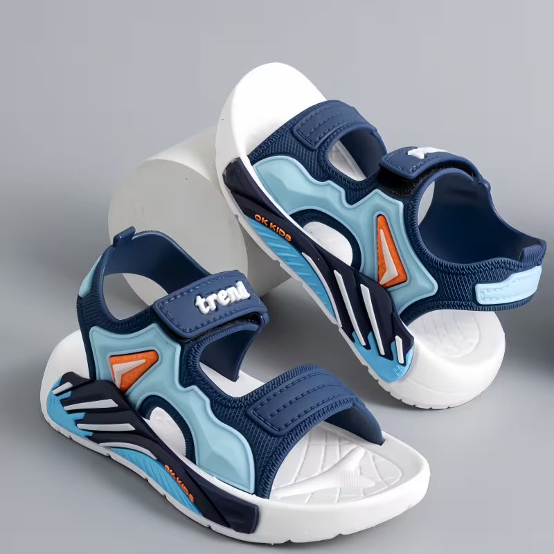 Children's blue and light blue sandals with white soles on a gray background